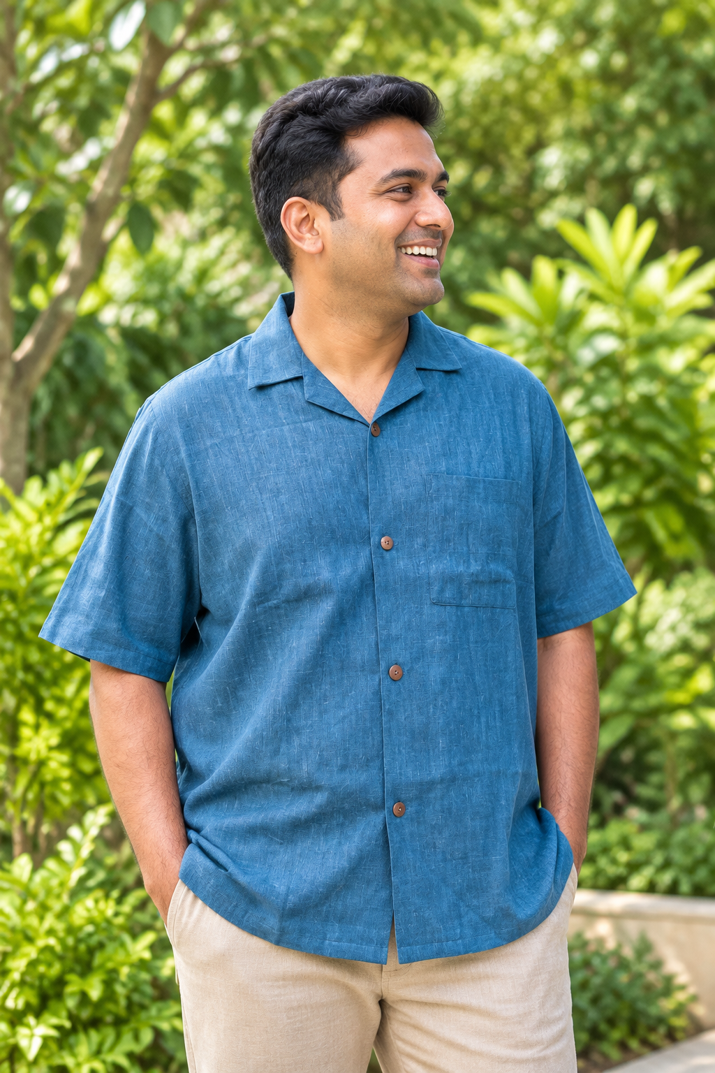 Blue Bomb steel-blue khadi shirt on a clean-shaven Indian man amid greenery
