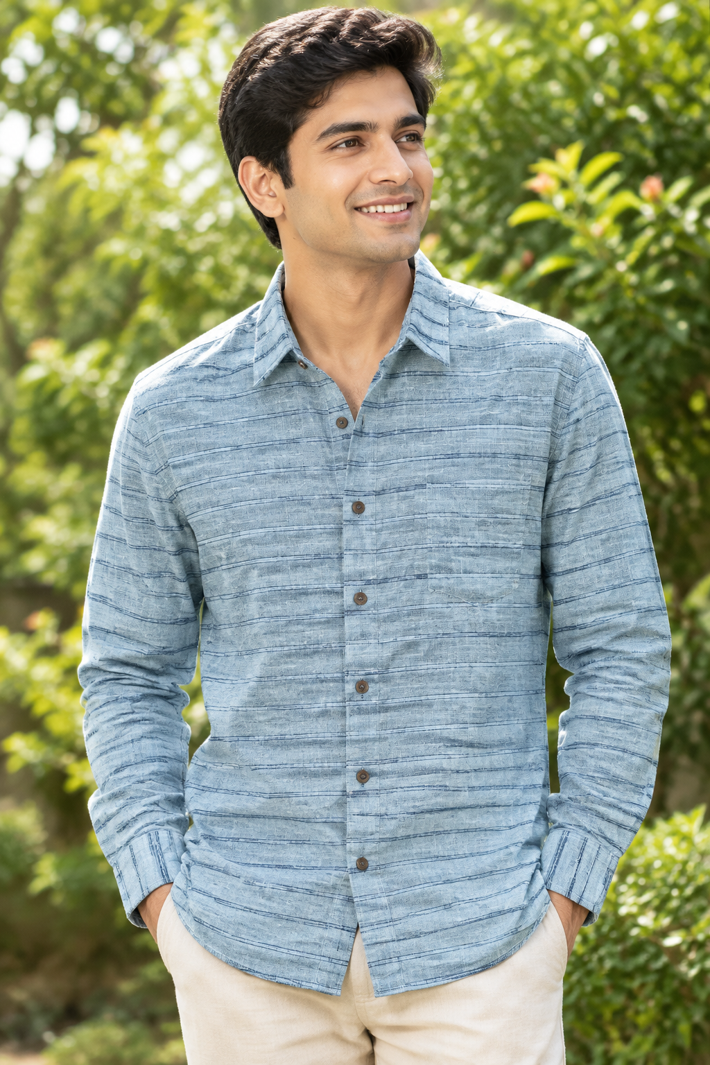Clean-shaven young adult Indian man wearing the Blue on Blue shirt in bright sunlight